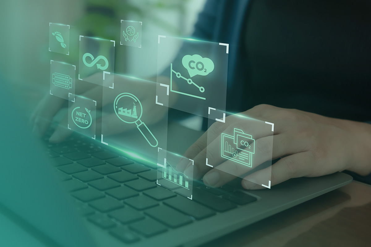 “Person reviewing digital carbon and emissions dashboards on a laptop, representing a CRREM (Carbon Risk Real Estate Monitor) Assessment for identifying building decarbonisation pathways.”