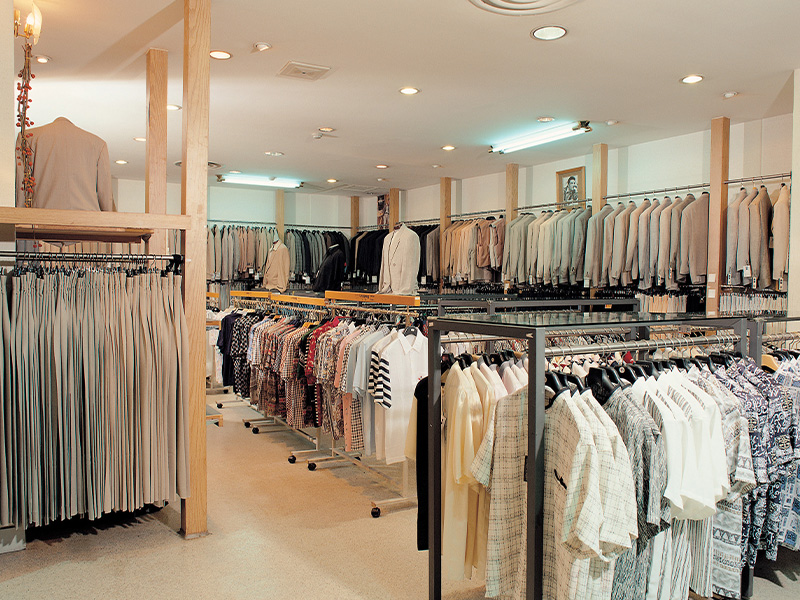 Clothing retail store interior with suits and garments on display, symbolising how energy market intelligence for procurement helps retail businesses save costs.