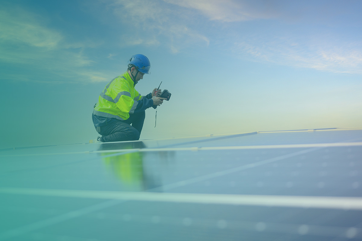 “Engineer inspecting rooftop panels as part of the Design and Installation Of Solar PV, EV Charging Points, and LED Lighting Solutions.”