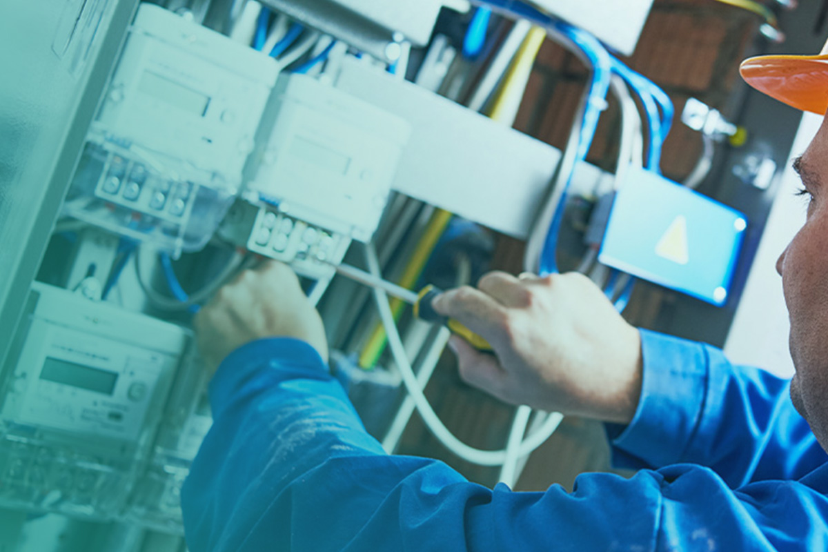 “Engineer inspecting electrical panels as part of AMR energy meters and BMS audits to improve monitoring and system performance.”
