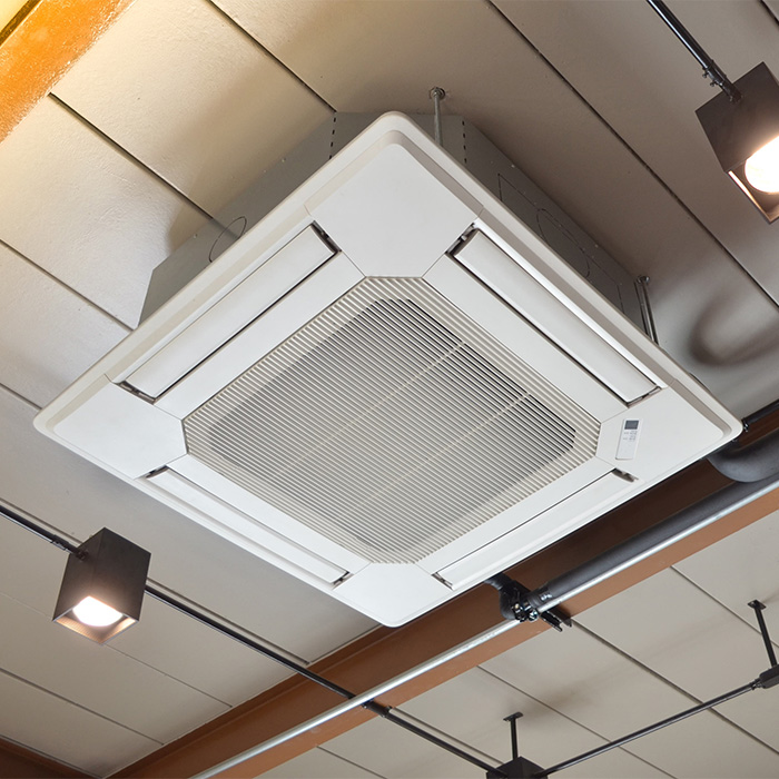Ceiling-mounted air conditioning unit subject to regular tm44 inspection.
