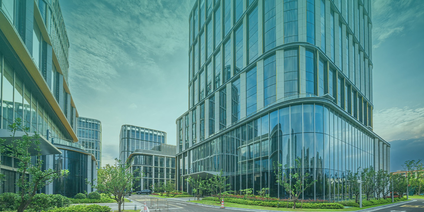 Modern commercial office buildings representing a portfolio that achieved MEES compliance through strategic upgrades.