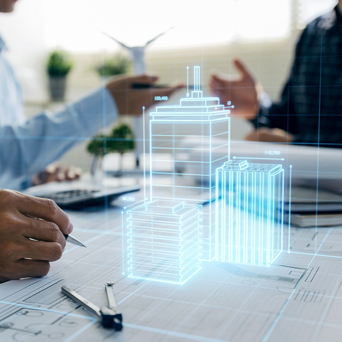 Architects discussing building plans with a digital overlay of skyscrapers, symbolising EPC assessments and planning requirements.