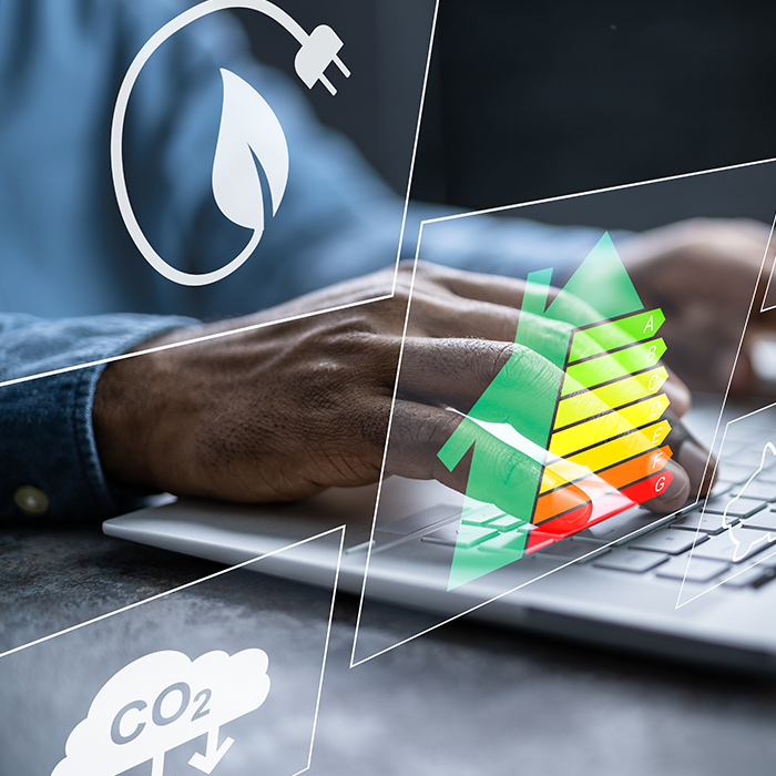 Person typing on a laptop with overlaid icons representing energy performance, sustainability, and an EPC rating chart.