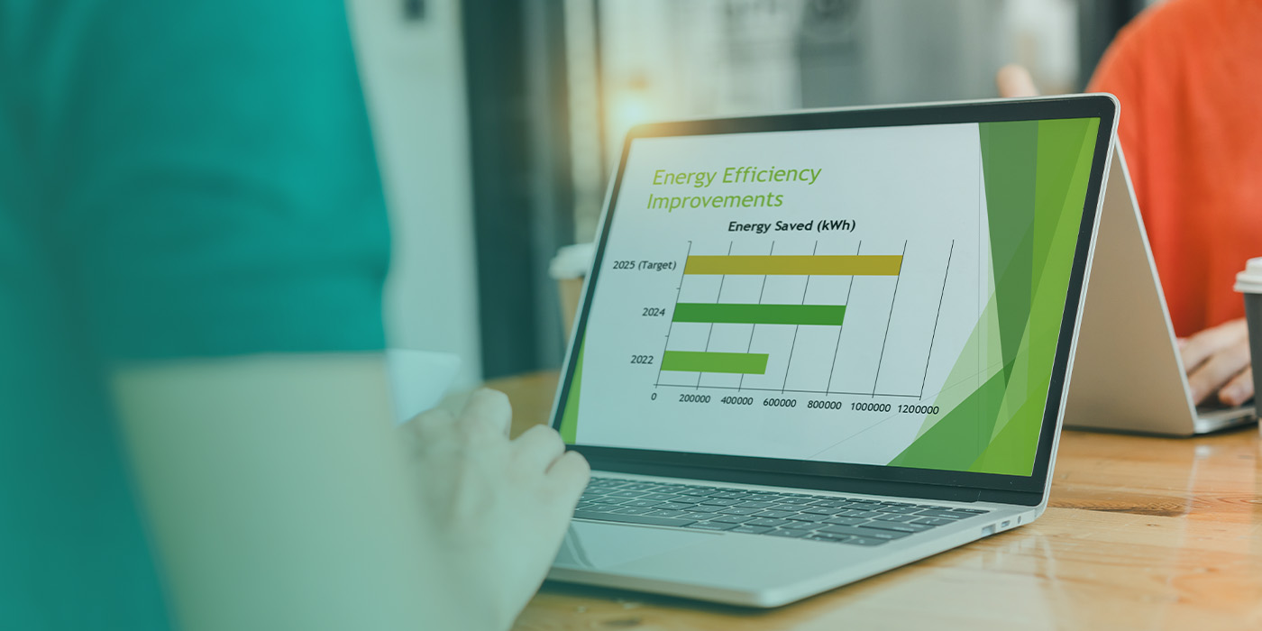 Laptop displaying energy efficiency improvements and carbon reduction data generated through an Optimised BMS.