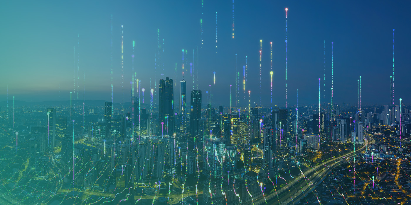 City skyline overlaid with digital data streams illustrating the wider impact of BMS Recommissioning on comfort, carbon and cost.